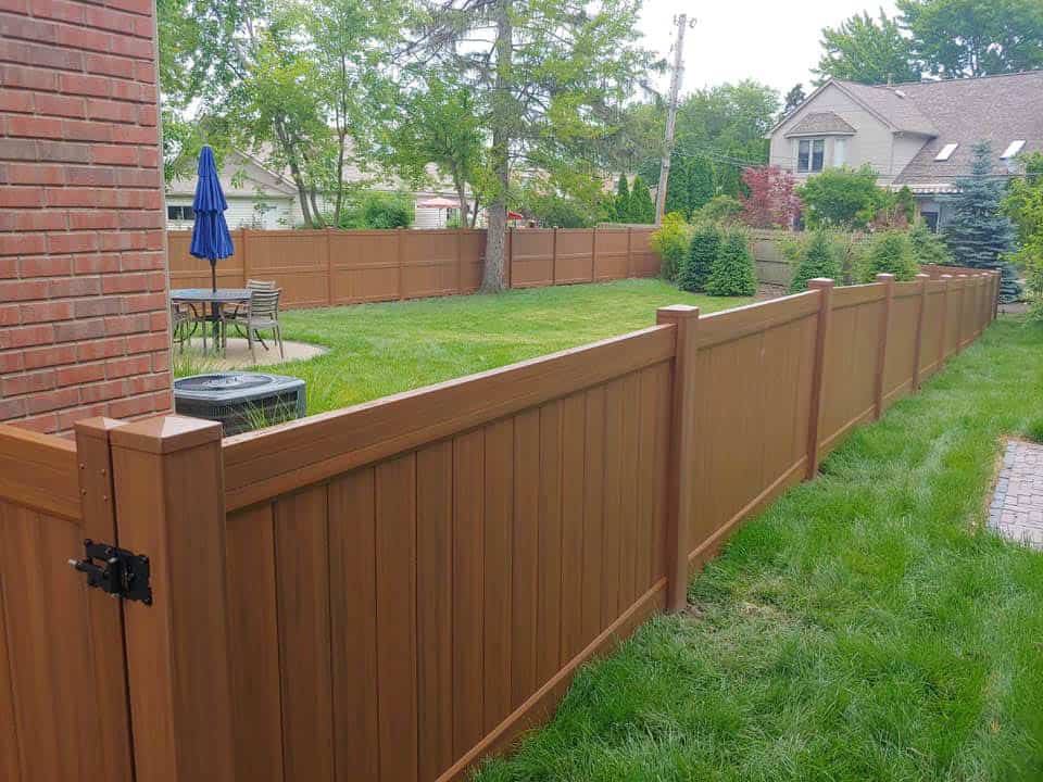 Backyard with wooden fence and patio furniture.