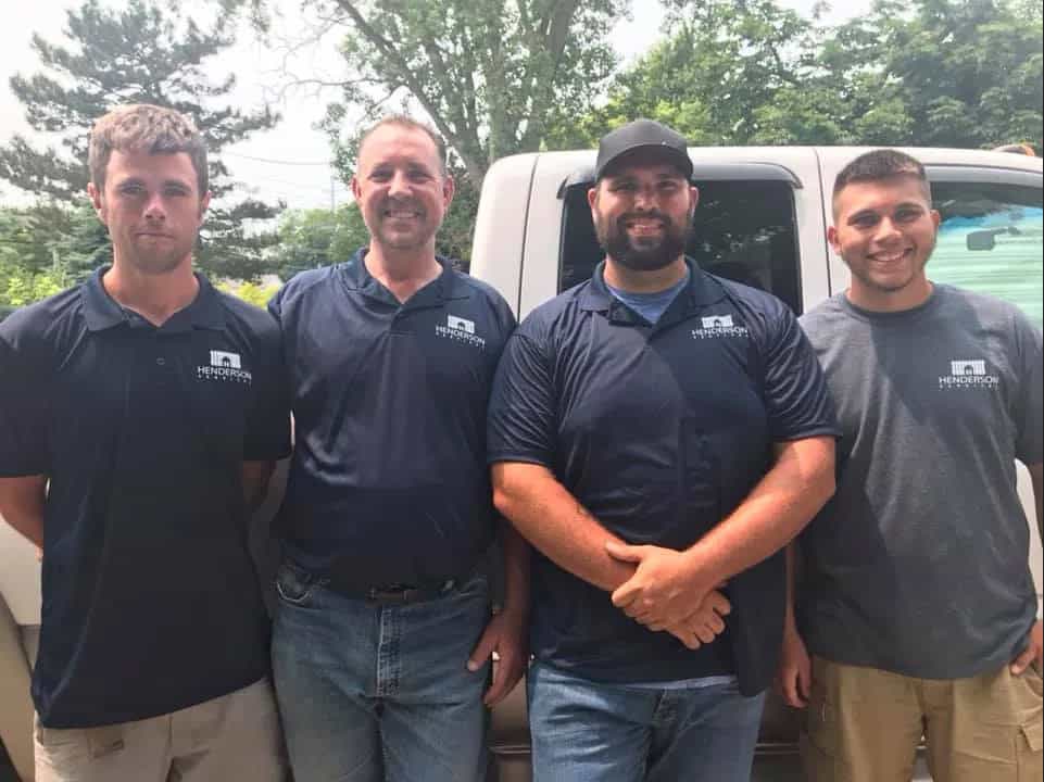 Group of four men in matching Henderson shirts.